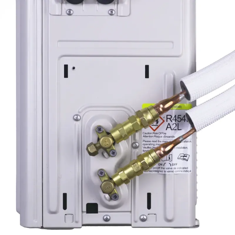 Brass fittings on two insulated pre-charged R-454B line sets tightened onto the service valves of a mini split outdoor unit, the connection every quick connect mini split uses