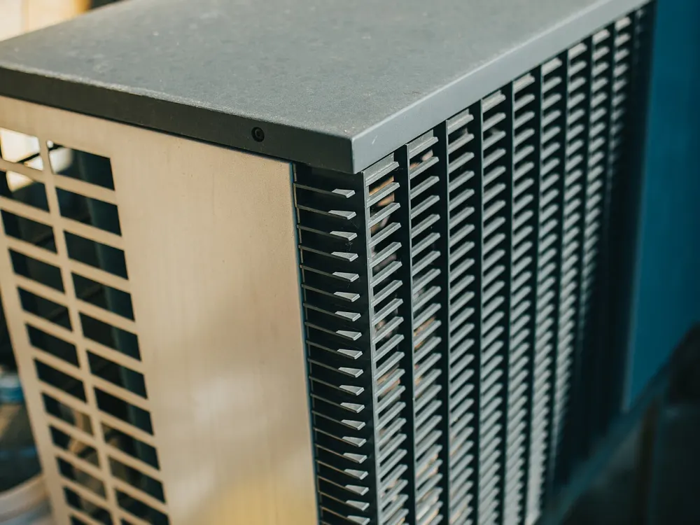 Outdoor air conditioner unit in a garden, the half of the system whose model number you use to look up a SEER2 rating